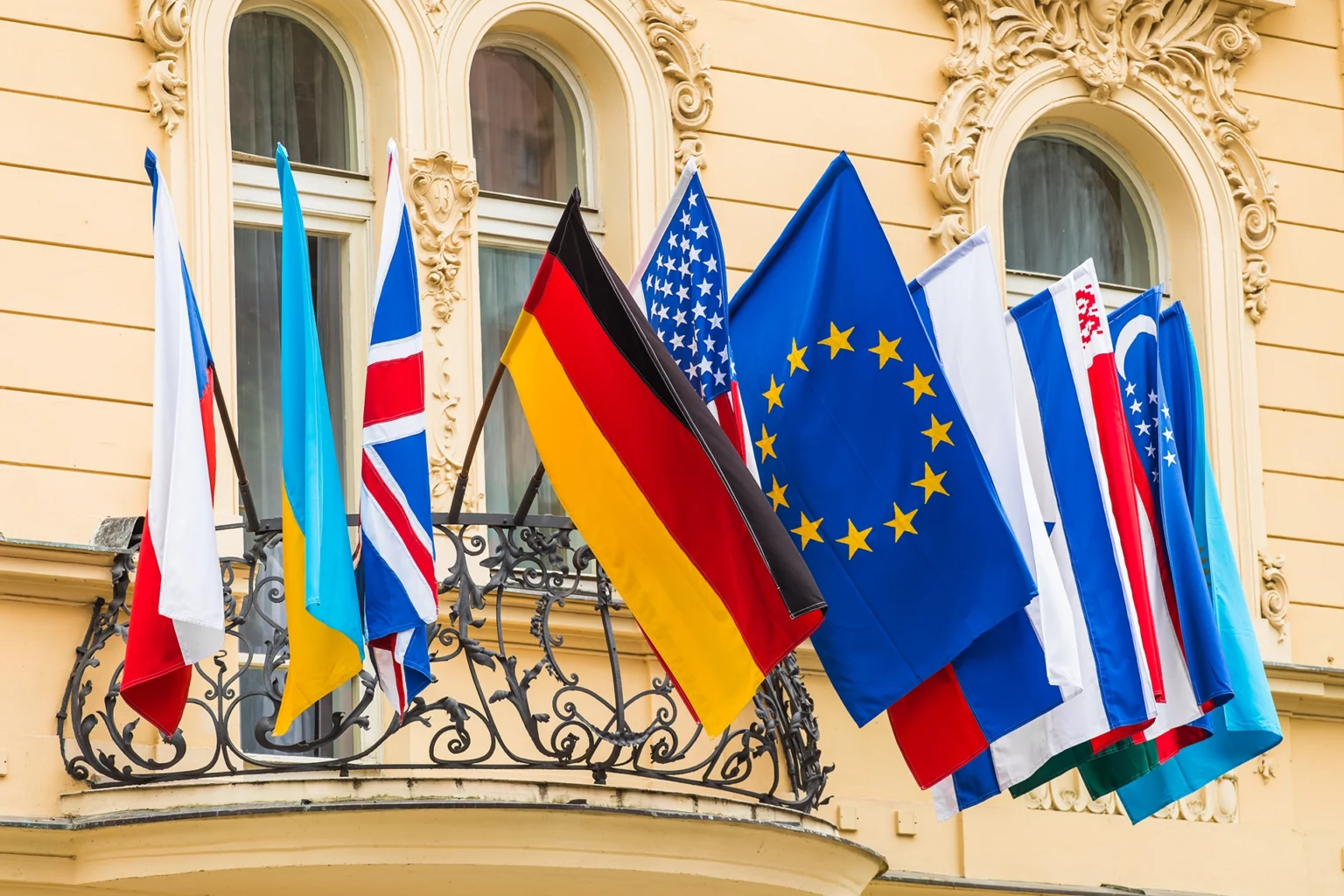 flags of many nations fly on building balcony 2026 03 19 05 42 00 utc