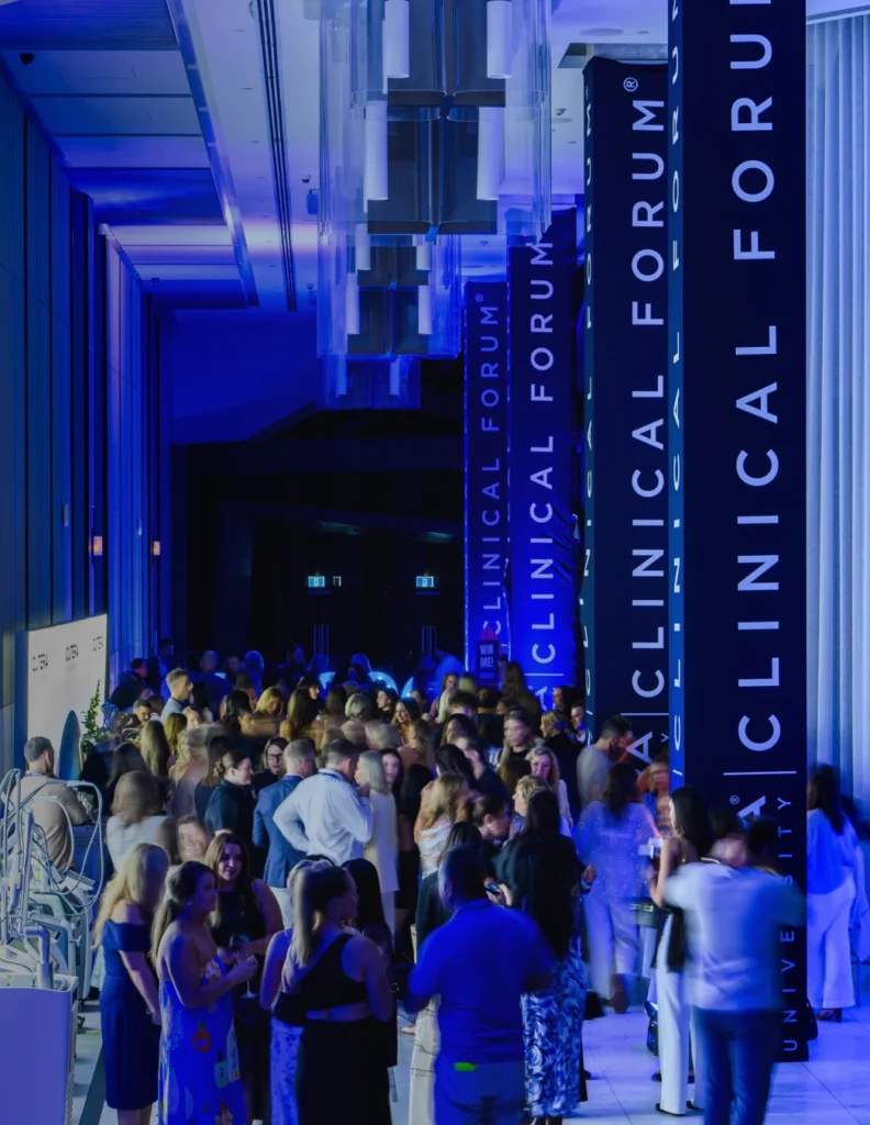 Crowd at a conference beneath blue Clinical Forum banners